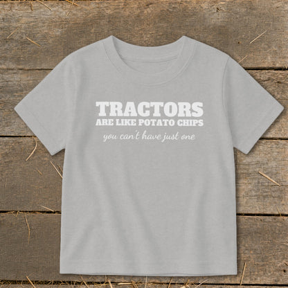 Light gray t-shirt with white text "TRACTORS ARE LIKE POTATO CHIPS you can't have just one".