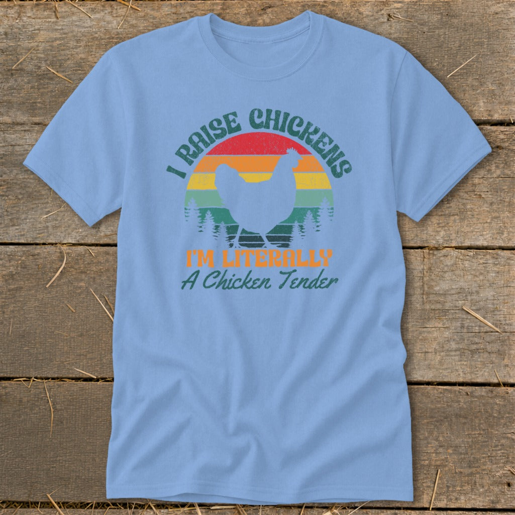 Light blue t-shirt with a graphic of a chicken, trees, and text "I Raise Chickens I'm Literally A Chicken Tender".