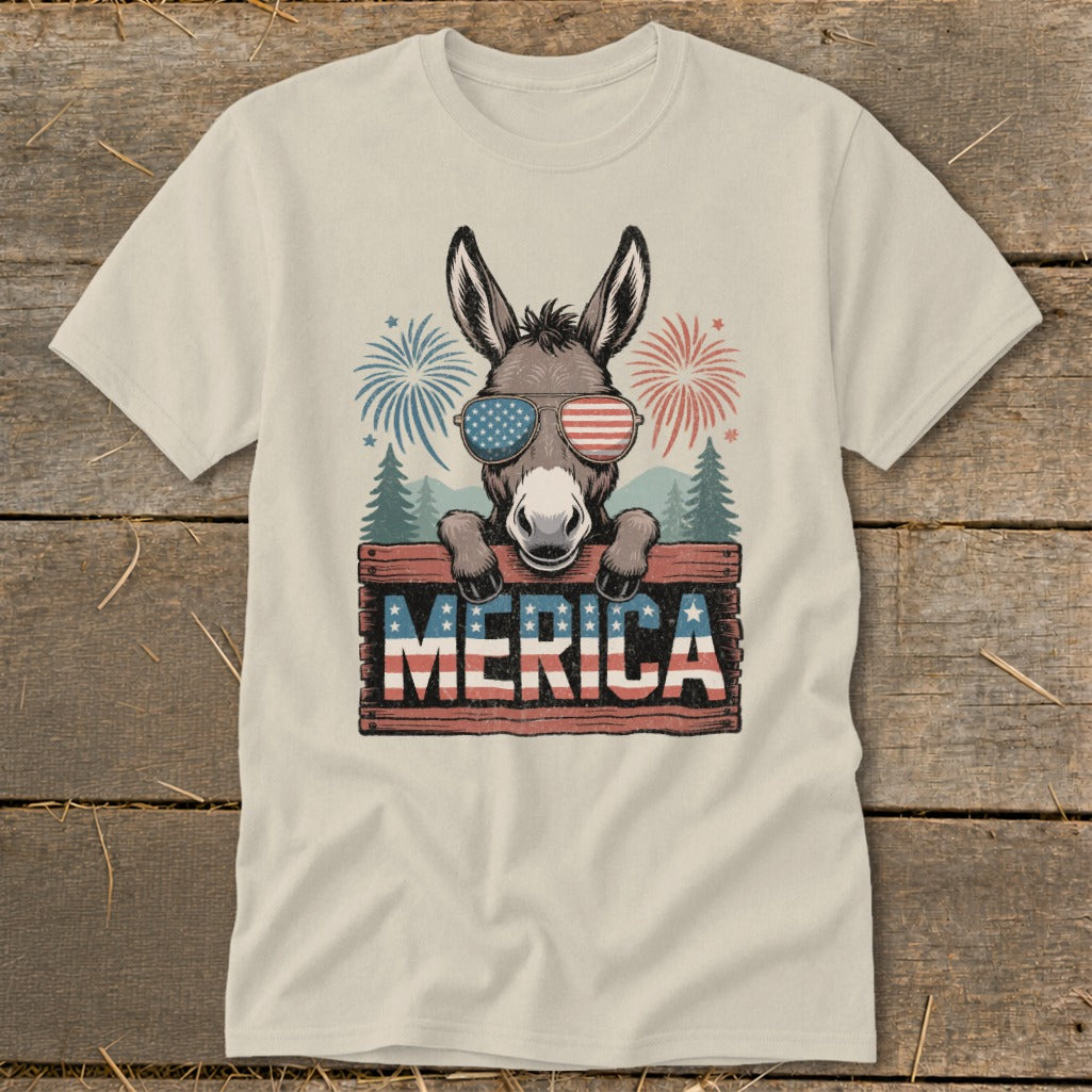 Donkey wearing American flag sunglasses holds sign saying MERICA with fireworks.