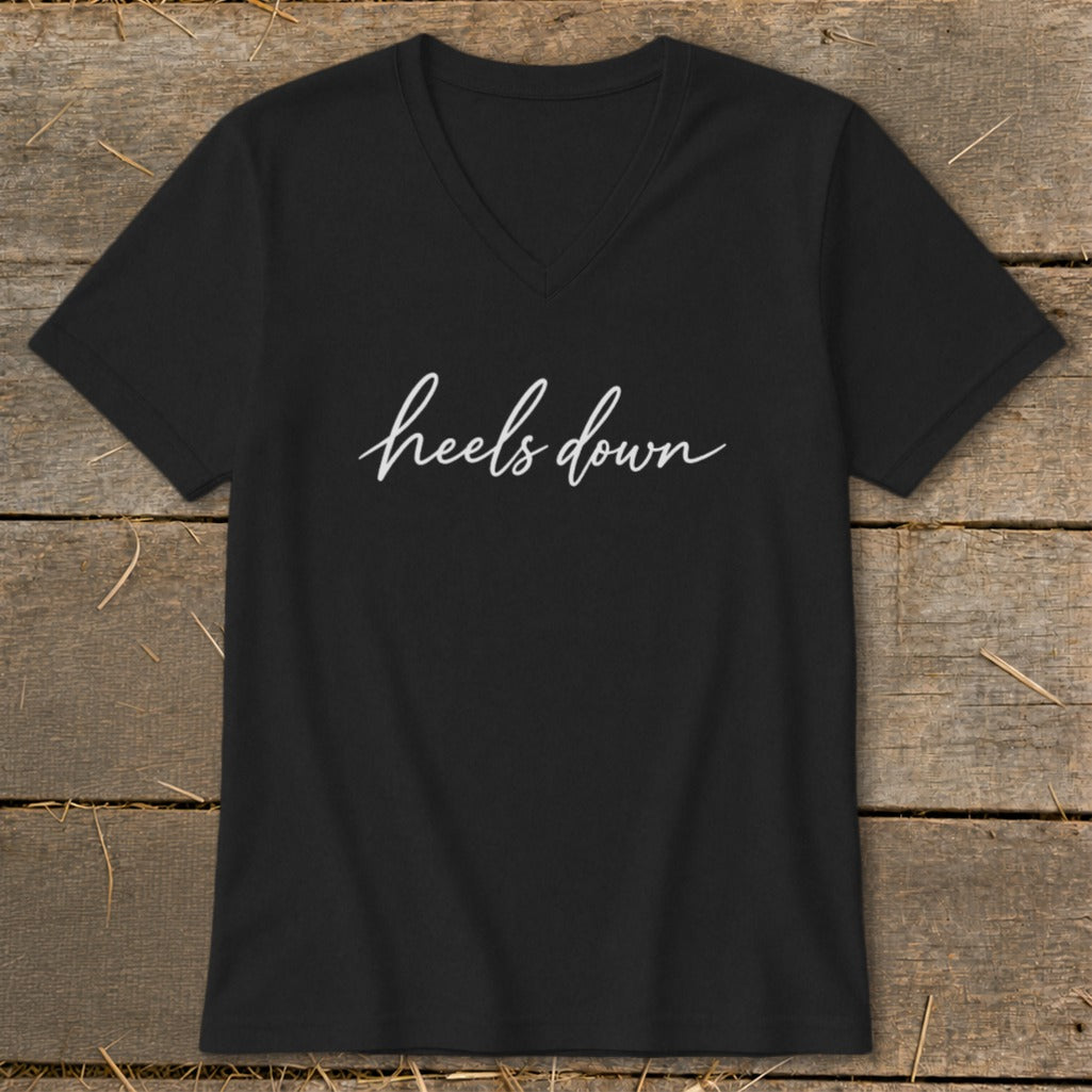 Black V-neck t-shirt with "heels down" in white cursive text.