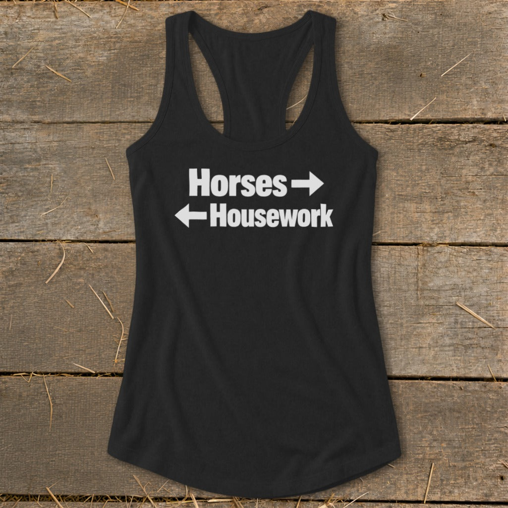 A black racerback tank top with white text that reads Horses with a right arrow and Housework with a left arrow.