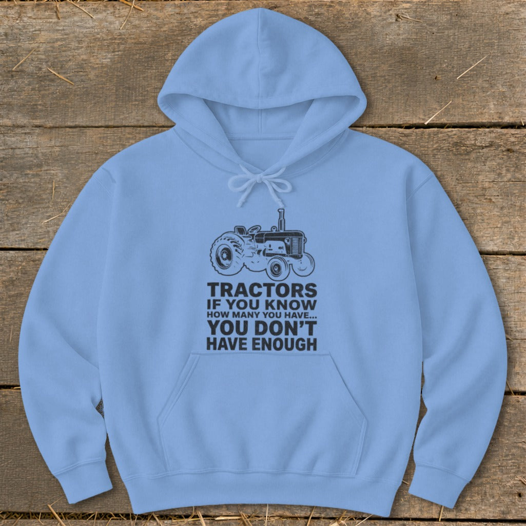 Light blue hoodie with a black tractor graphic and text about tractors.