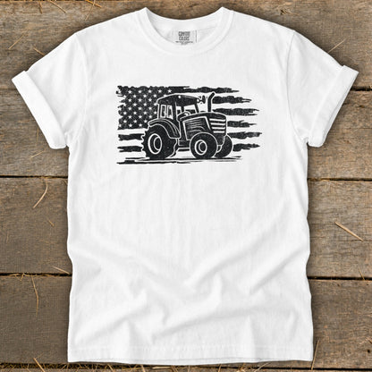 White t-shirt with distressed tractor silhouette on American flag graphic.