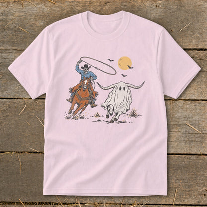 Skeleton cowboy on horse lassoing a longhorn ghost under a yellow moon.