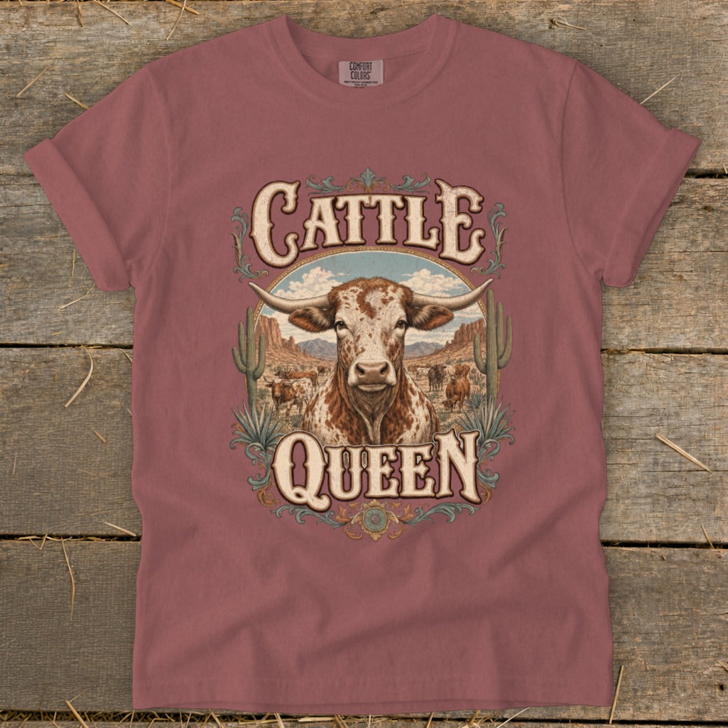 T-shirt with "Cattle Queen" text and longhorn bull graphic in desert scene.