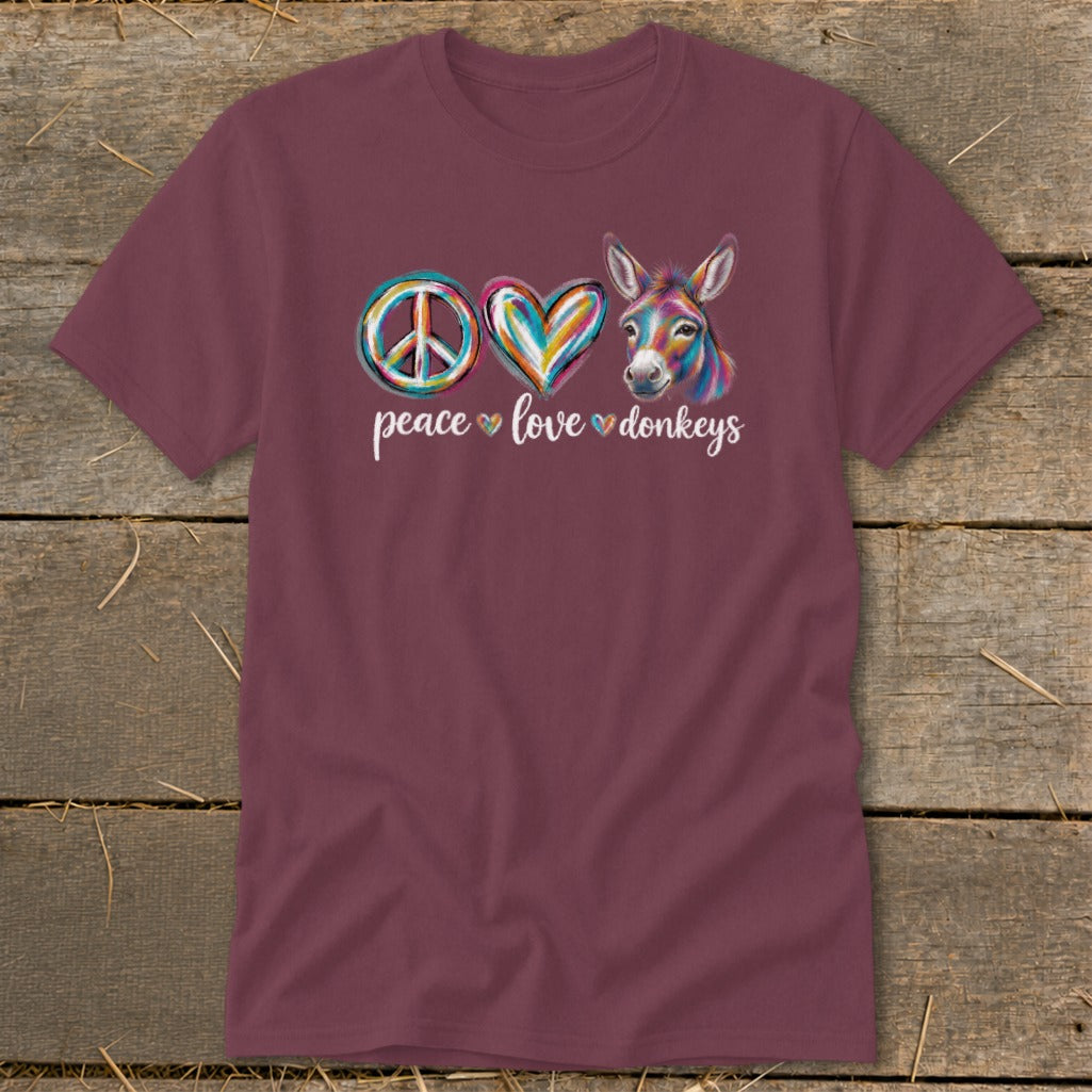 Maroon t-shirt with peace sign, heart, and colorful donkey graphic.