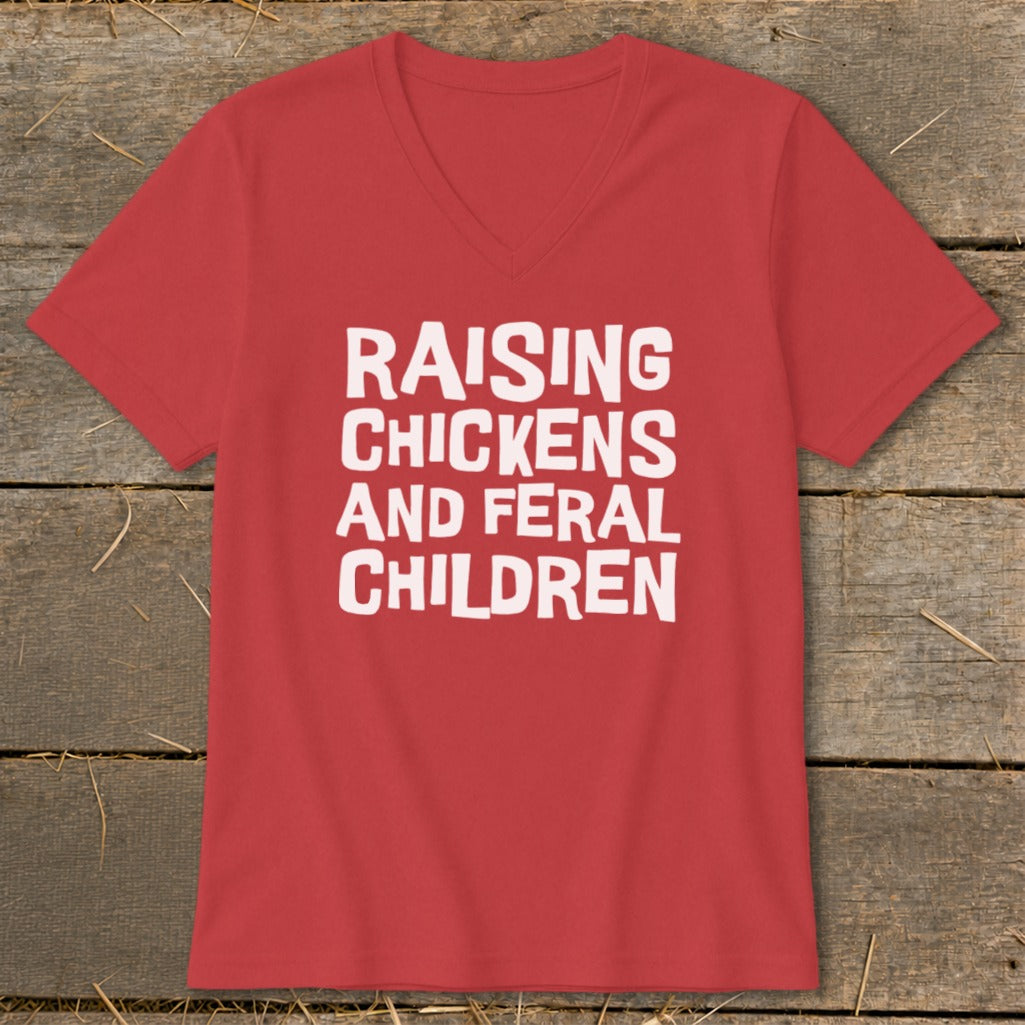 Red v-neck t-shirt with white text reading "RAISING CHICKENS AND FERAL CHILDREN".