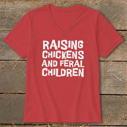 Red v-neck t-shirt with white text reading "RAISING CHICKENS AND FERAL CHILDREN".