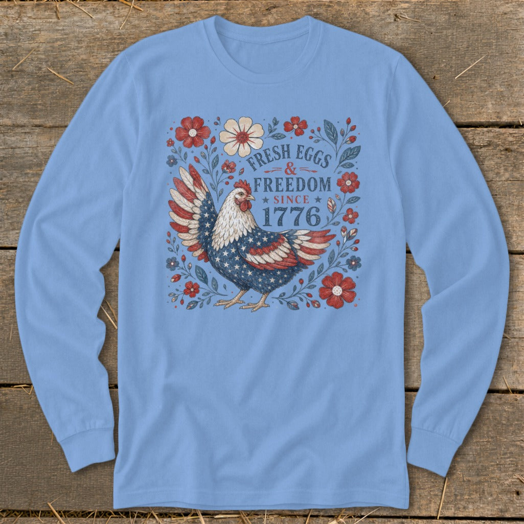 Light blue long sleeve shirt with chicken, flowers, and text "Fresh Eggs & Freedom Since 1776".