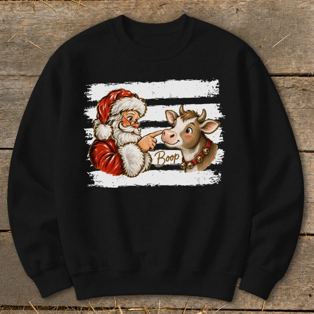 Santa booping a cow's nose with the word "Boop" on a black sweatshirt.