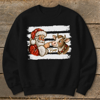 Santa booping a cow's nose with the word "Boop" on a black sweatshirt.