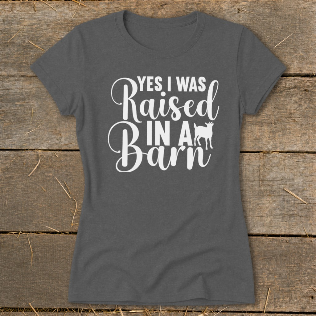 Dark gray t-shirt with white text "YES I WAS Raised IN A Barn" and a goat silhouette.