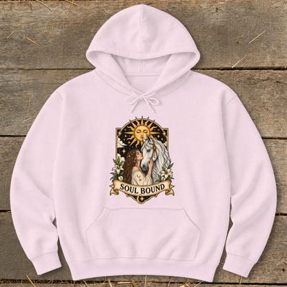 Pink hoodie with a "Soul Bound" graphic of a woman and horse with the sun and stars.