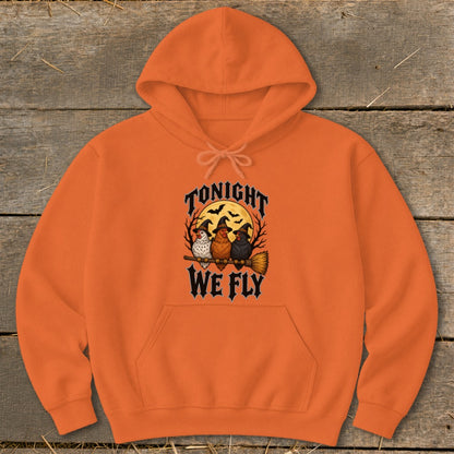 Orange hoodie with "Tonight We Fly" and three chickens in witch hats on a broom.