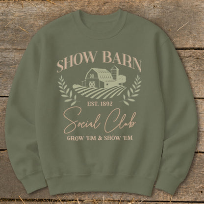 Olive sweatshirt with "Show Barn Social Club" text and farm graphic.
