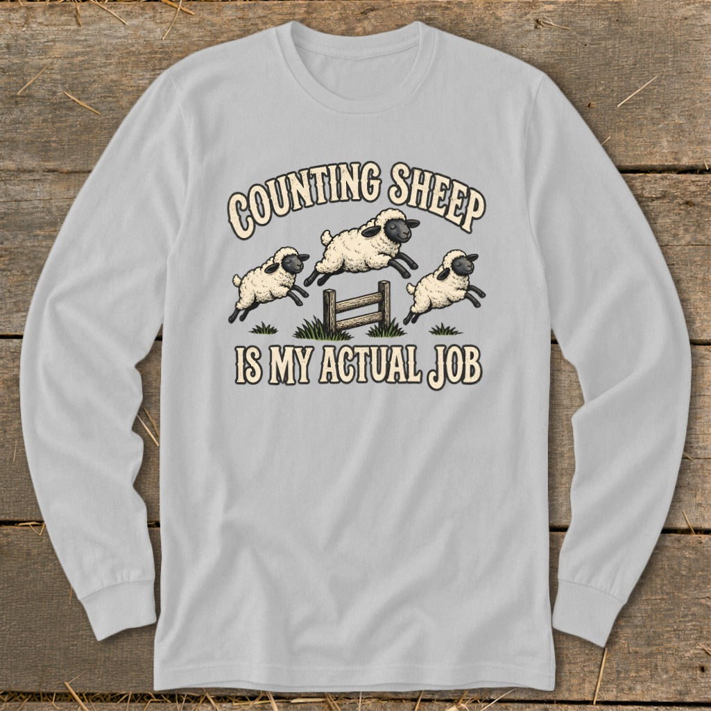 Light grey long-sleeve shirt with "Counting Sheep Is My Actual Job" and cartoon sheep jumping.