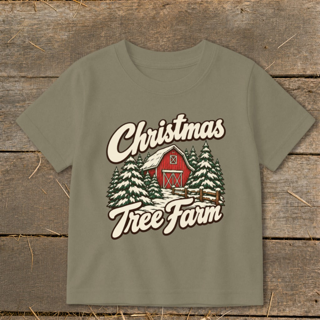 T-shirt with "Christmas Tree Farm" text and illustration of a red barn surrounded by pine trees.