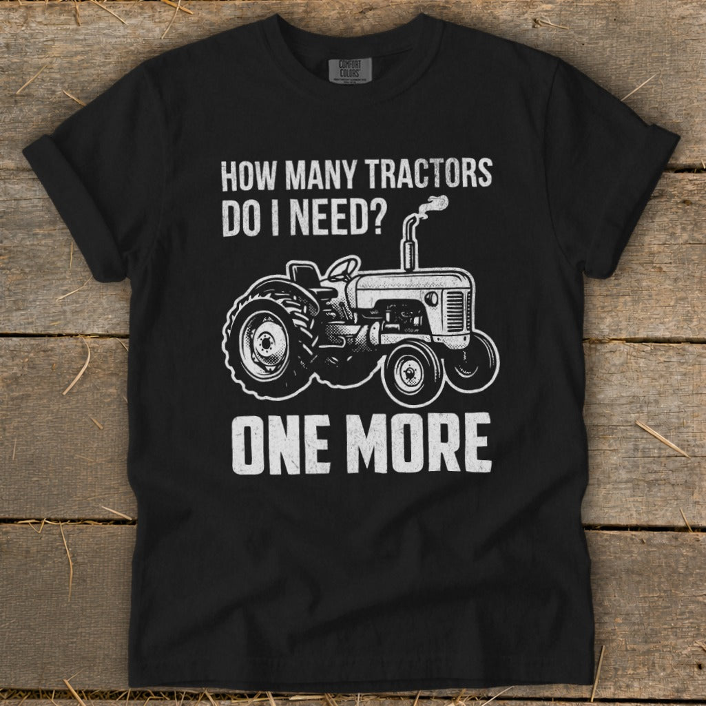 Black t-shirt with "How Many Tractors Do I Need? One More" and tractor graphic.