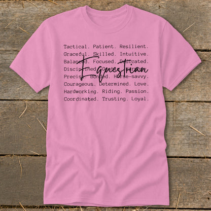 Pink t-shirt with list of traits describing a "girl boss equestrian" or "horse woman."