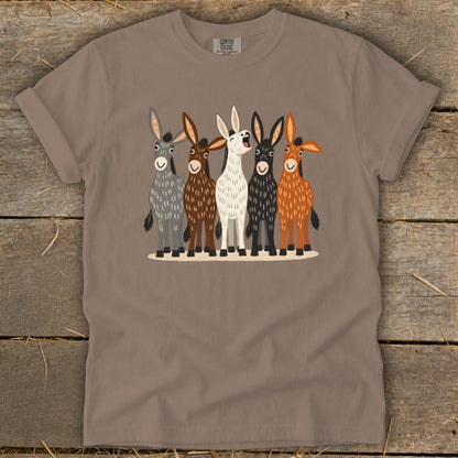 A crewneck t-shirt featuring a cartoon illustration of five colorful donkeys standing in a row.