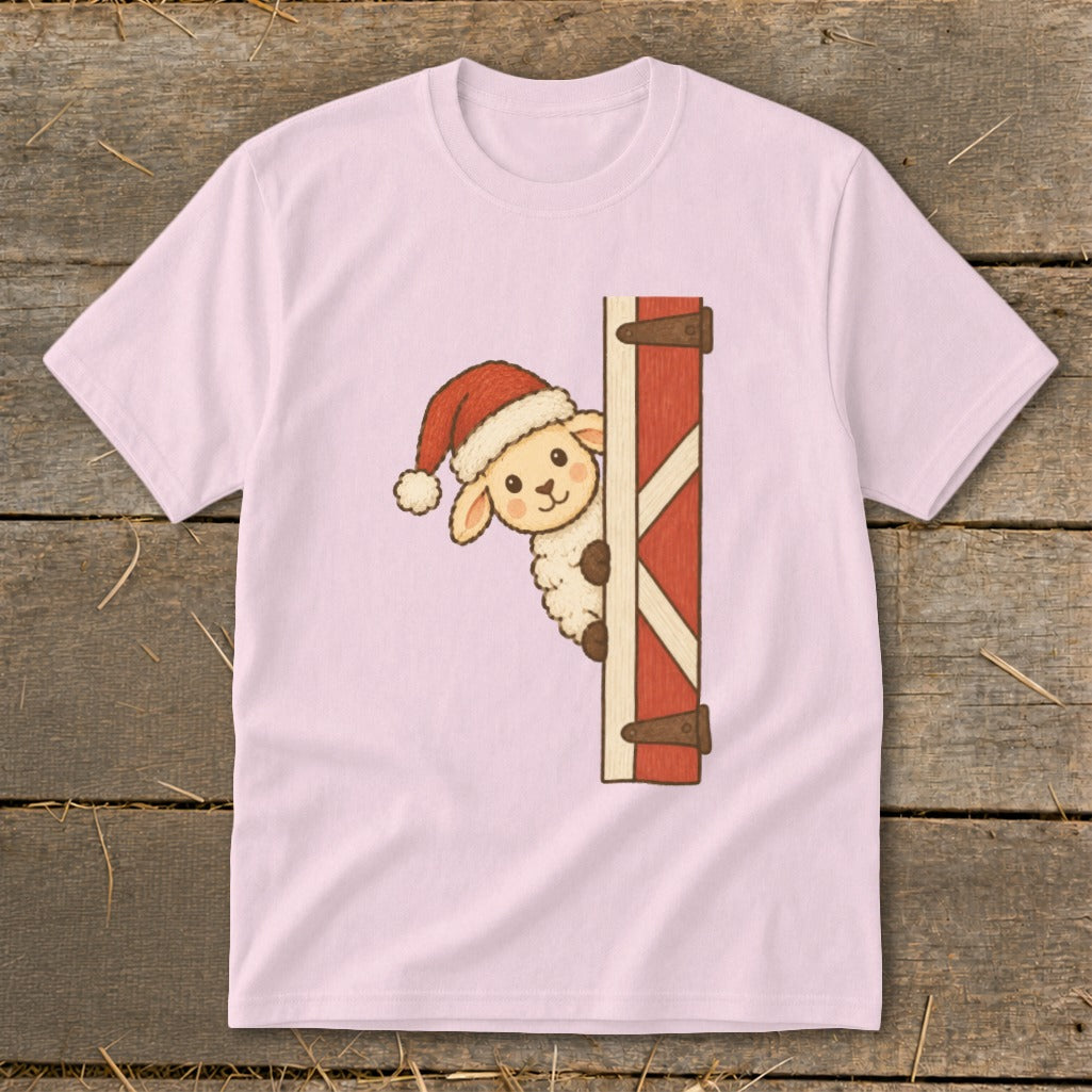 Pink t-shirt with a sheep wearing a Santa hat peeking behind a barn door.