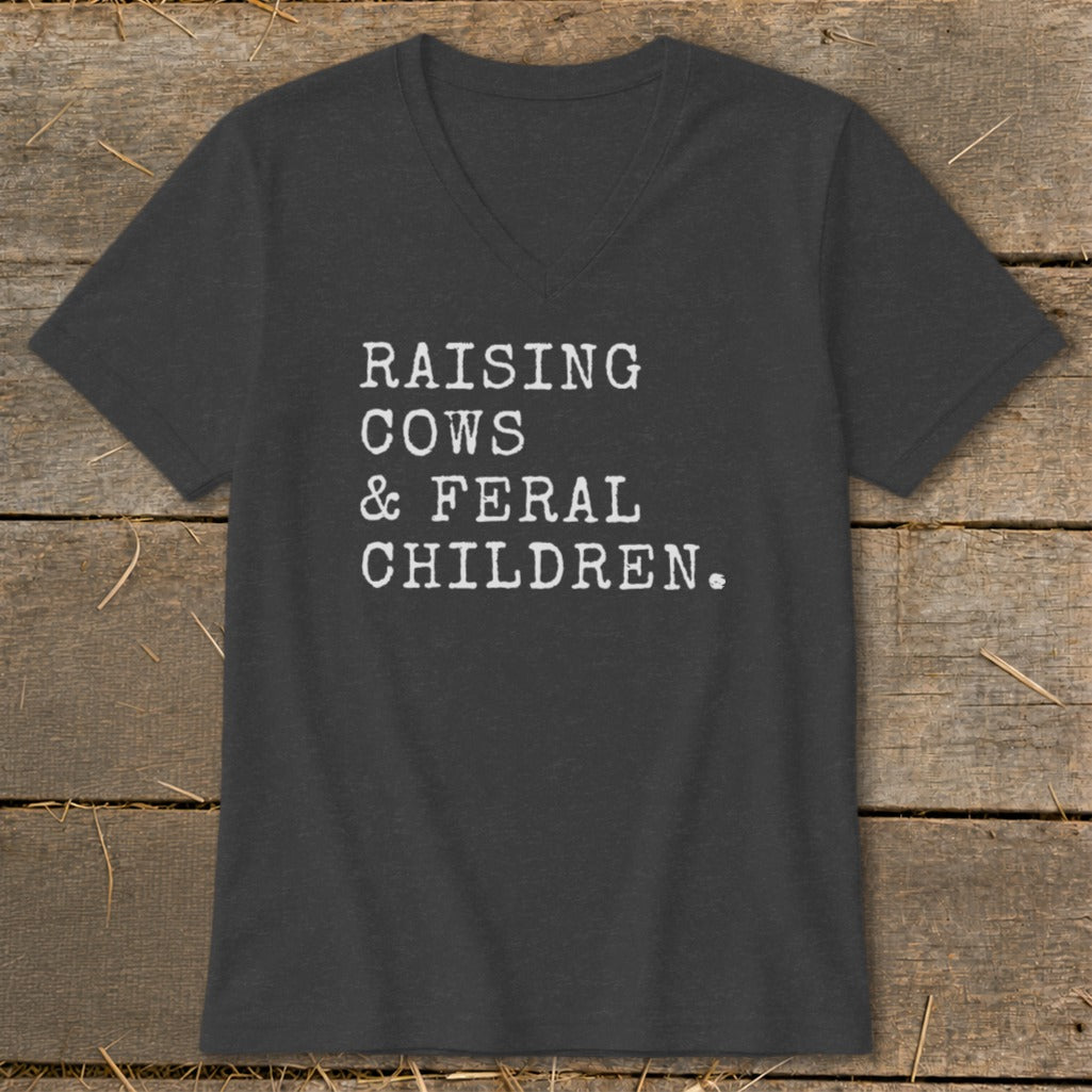 Dark grey v-neck t-shirt with white text: "RAISING COWS & FERAL CHILDREN."