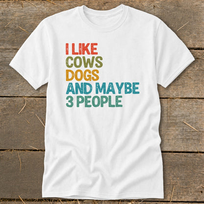 White t-shirt with text "I LIKE COWS DOGS AND MAYBE 3 PEOPLE".