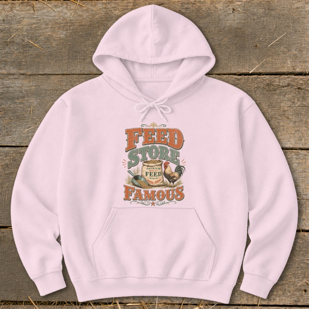 Pink hoodie with "Feed Store Famous" text, sack of feed, and rooster graphic.