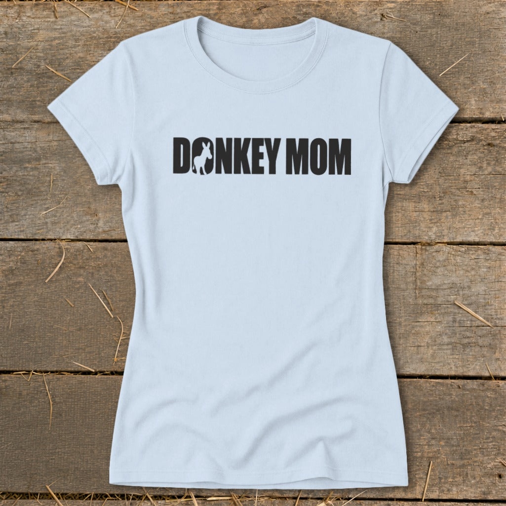 A light blue women's t-shirt with black text reading DONKEY MOM, featuring a small donkey silhouette inside the letter O.