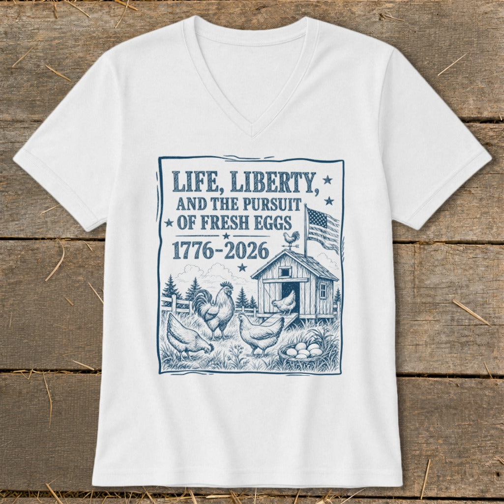 White t-shirt with graphic "Life, Liberty, and the Pursuit of Fresh Eggs 1776-2026" and chickens.