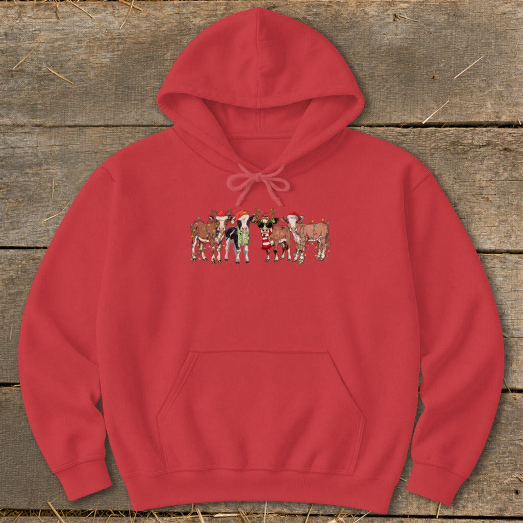 Red hoodie with a print of cows in Christmas attire and lights.