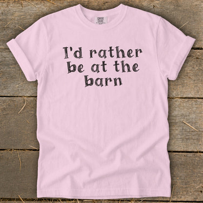Pink t-shirt with black text that reads "I'd rather be at the barn".