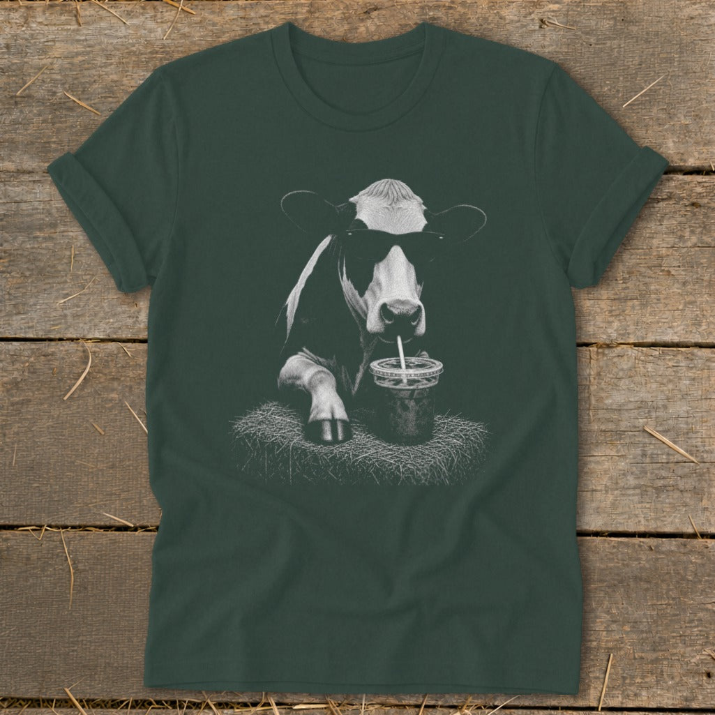 Black and white cow wearing sunglasses, drinking from a straw.