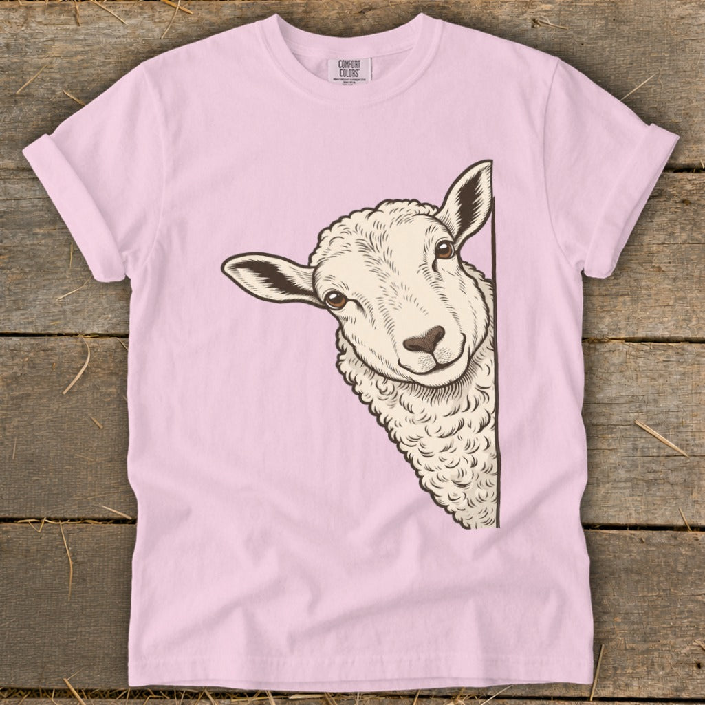 Pink t-shirt with a drawing of a sheep peeking from the side.