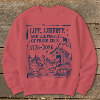 Red sweatshirt with a navy blue graphic of chickens, a coop, and text about fresh eggs.