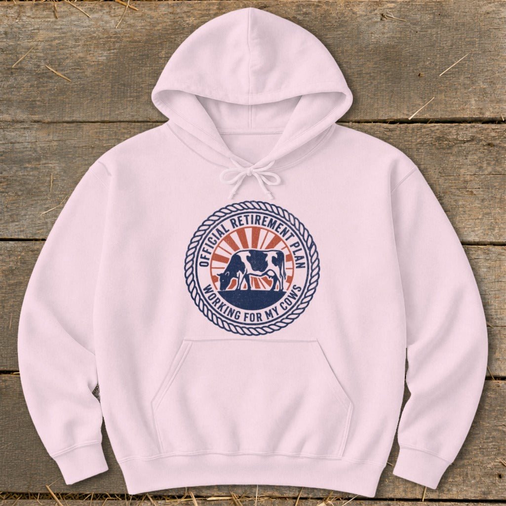 Pink hoodie with a circular graphic featuring a cow and the text "Official Retirement Plan Working for My Cows".