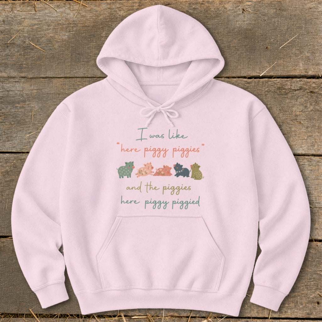 Pink hoodie with "I was like 'here piggy piggies'" and pig illustrations.