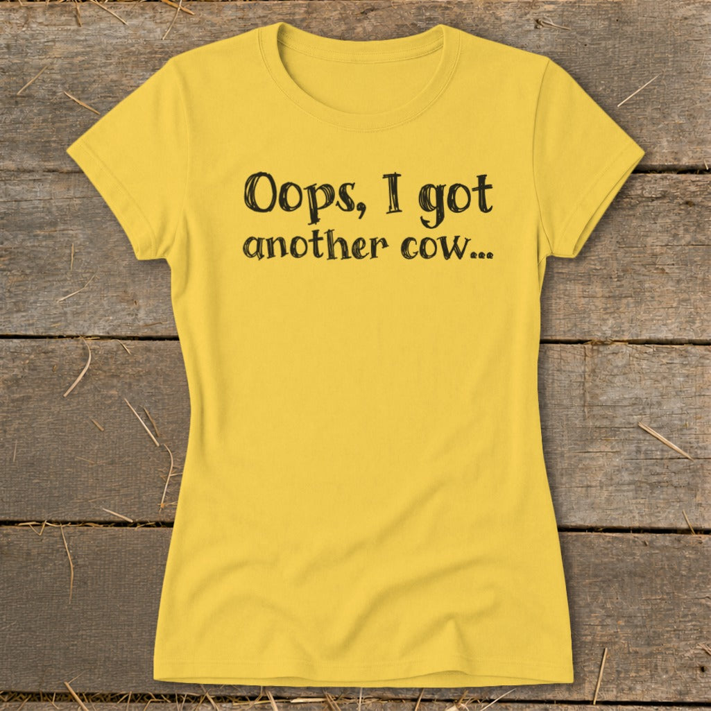 Yellow t-shirt with black text that reads "Oops, I got another cow...".