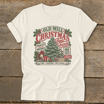 Cream t-shirt with Old Mill Christmas Tree Farm graphic featuring pine tree, gifts, and text.