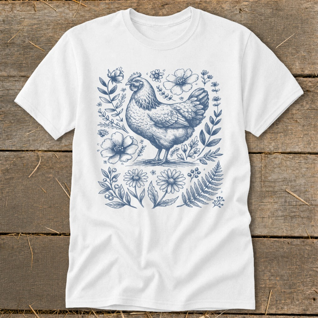 White t-shirt with blue chicken and floral illustration.