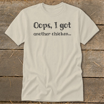 Cream t-shirt with black text reading "Oops, I got another chicken..."