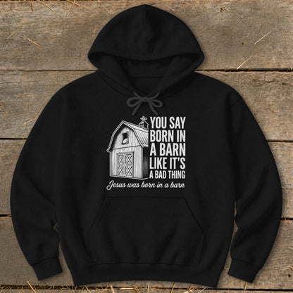Black hoodie with barn graphic and text "Jesus was born in a barn".