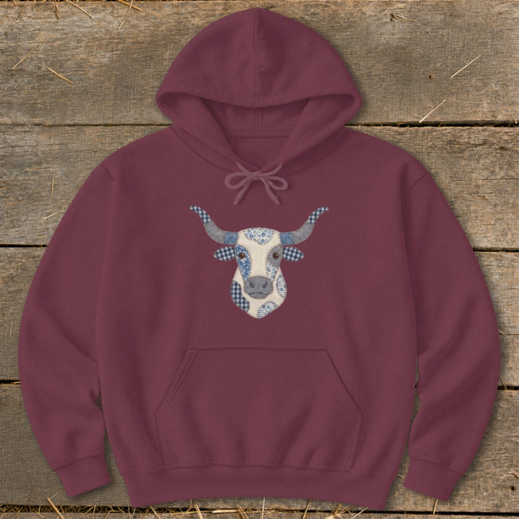 Maroon hoodie with a patchwork bull face graphic in blue and white.