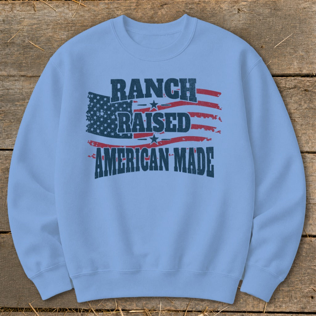 Light blue sweatshirt with distressed American flag and text: Ranch Raised American Made.
