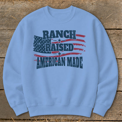 Light blue sweatshirt with distressed American flag and text: Ranch Raised American Made.