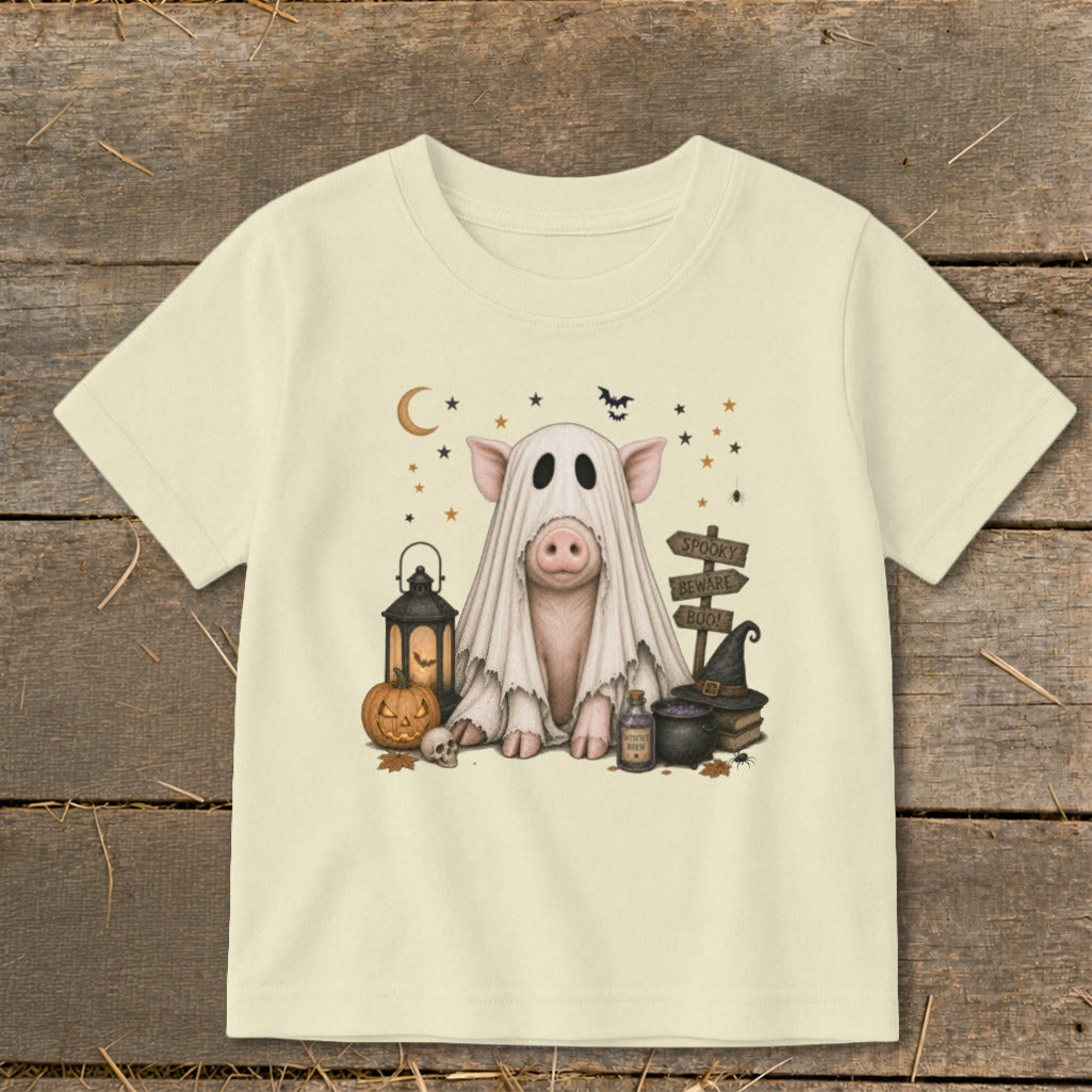 Pig wearing a ghost costume with Halloween decorations and "Spooky Beware Boo!" sign.