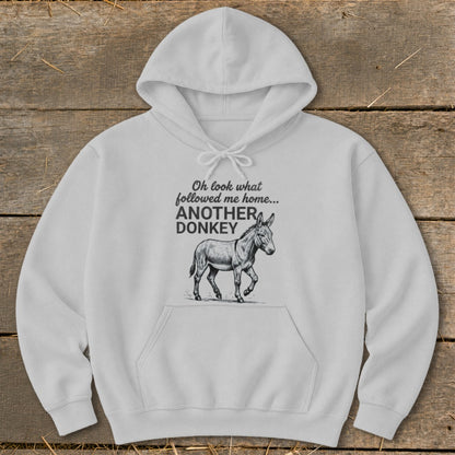 White hoodie with text "Oh look what followed me home... ANOTHER DONKEY" and a donkey illustration.