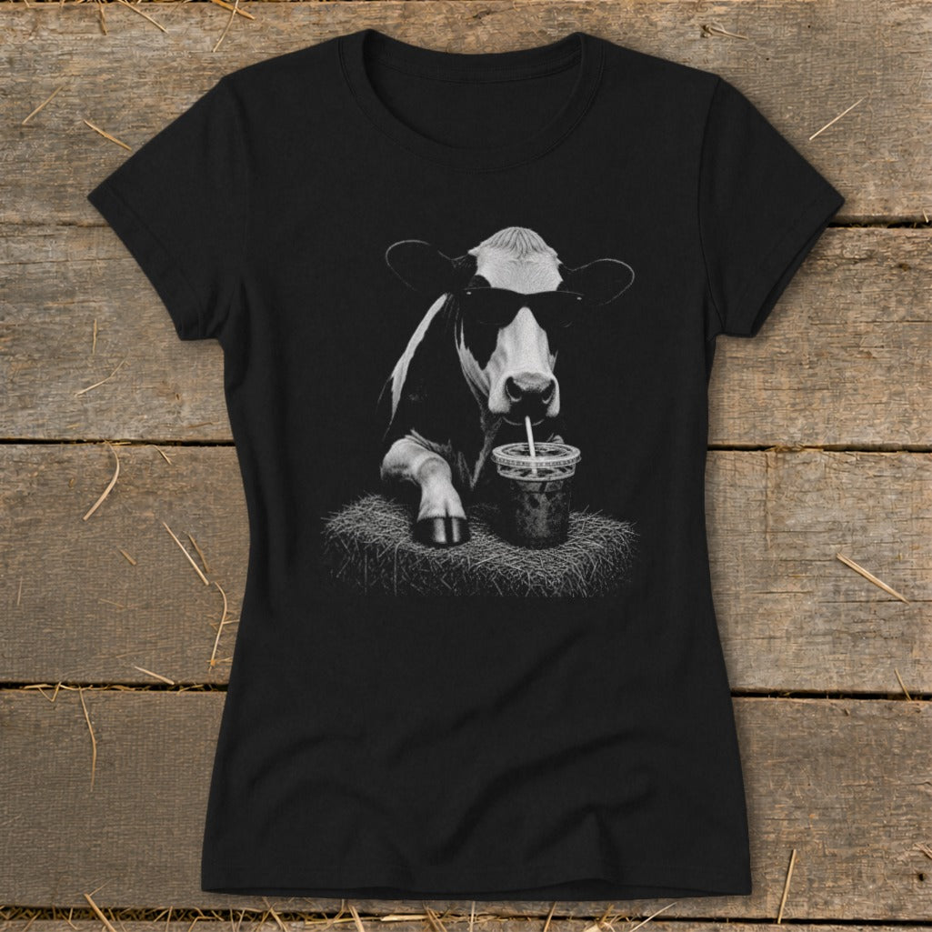 Black t-shirt with a graphic of a cow wearing sunglasses drinking a beverage.