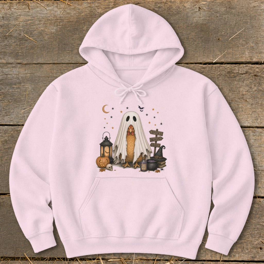 Pink hoodie with chicken in ghost costume and Halloween decorations.