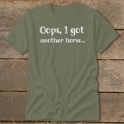 Olive green t-shirt with white text "Oops, I got another horse..."
